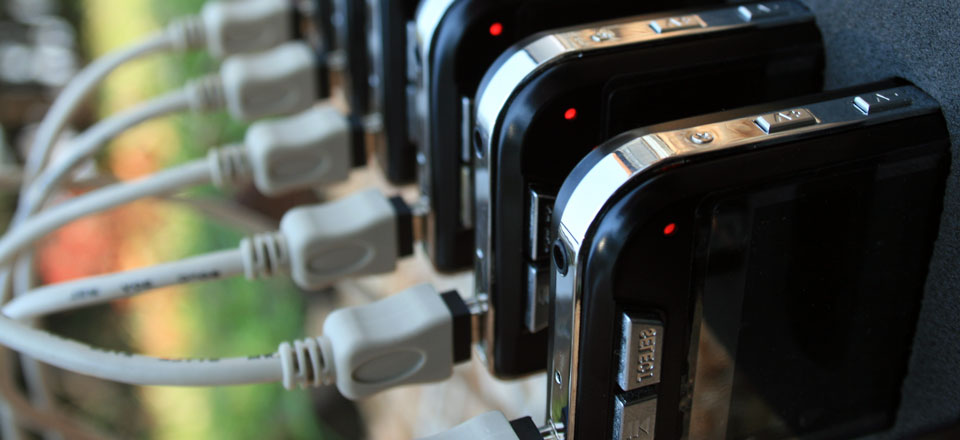 A set of ten handheld devices charging